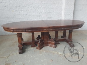 картинка Антикварный столовый гарнитур: стол с массивными резными опорами и стулья (12 шт.) в кожаной обивке зеленого цвета салоне старинных вещей "Шебби" являющийся официальным дистрибьютором в России и Беларуси