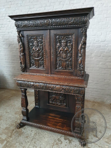 картинка Антикварный поставец из дуба с резьбой на мифологический сюжет салоне старинных вещей "Шебби" являющийся официальным дистрибьютором в России и Беларуси