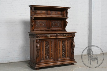 Антикварный ореховый буфет с плотной резьбой в мифологической тематике, декорированный резными барельефами код. BE107581